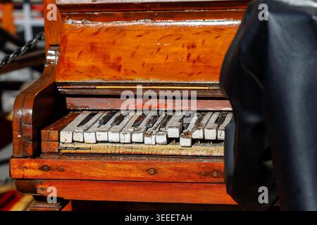 Old wooden piano with missing and broken keys in disrepair Stock Photo