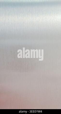 Macro image shows brushed metal texture. Smooth, even lighting emphasizes cool silver tones with subtle gradations, suitable for backgrounds or indust Stock Photo