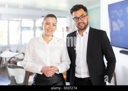 man and woman standing in the background of modern office Stock Photo