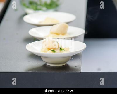 Assorted gourmet vegetable appetizers with tartines and zucchini rolls served as elegant finger food on a catering buffet table. Stock Photo