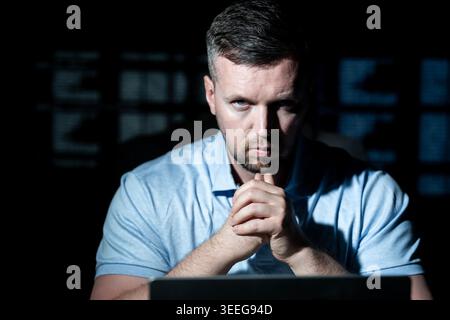 Network security specialist uses laptop. Network security specialist monitors cyber attack. Network security specialist analyzes code screen. Network Stock Photo