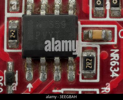 Close-Up Detail of Red Circuit Board with IC and SMD Parts Stock Photo