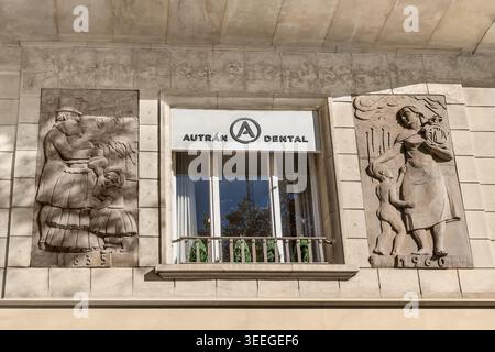 Barcelona, Spain - November 26,2021: Antique bas-reliefs and a modern sign on the facade of a building at 86 Passeig de Gracia in Barcelona Stock Photo