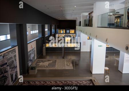 Pella, Greece - 14 Aug 24: Wide interior view of the Archaeological Museum of Pella showing exhibition cases, floor mosaics, and modern gallery archit Stock Photo