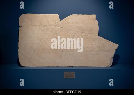 Vergina, Greece - 14 Aug 24: Marble inscription slab with carved Greek text displayed in the Museum of Aigai in Vergina, Central Macedonia, Greece. Stock Photo