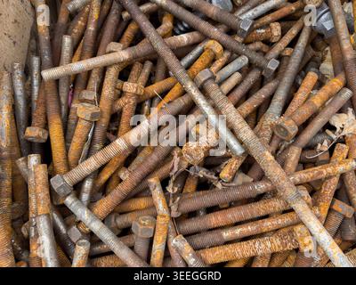 Old, rusty screws separated for the scrap metal collection at the recycling center. Stock Photo