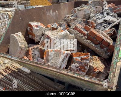 Container with construction rubble from demolition work (old bricks) Stock Photo
