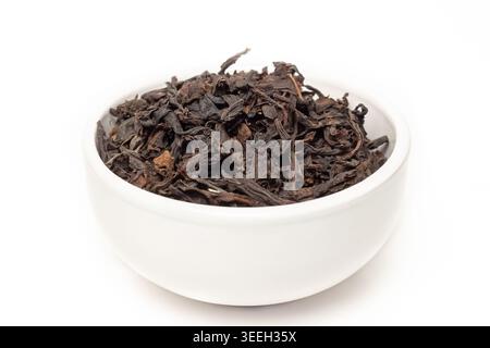 Black classic aroma dry leaves healthy tea with ceramic plate isolated on white background Stock Photo
