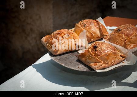 Traditional Cypriot easter pastries made with mixture of various cheese and halloumi, baked in clay oven flaounes flaouna Stock Photo