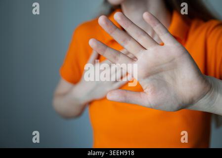 Anonymous female crossing hands with defensive gesture. Concept of rejection, protest, protection, women rights and anti harassment awareness campaign Stock Photo