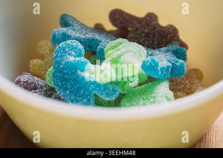 Sugar coated gummy candies in various colors filling a ceramic bowl Stock Photo