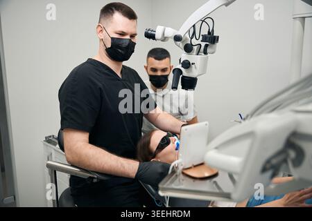 Female patient receiving dental care in modern clinic Stock Photo