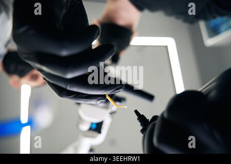 Adult male Caucasian conducting experiment in modern laboratory Stock Photo