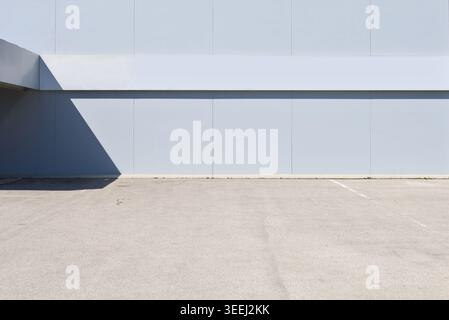 Gray prefab concrete block facade with street in front. Background for copy space. Stock Photo