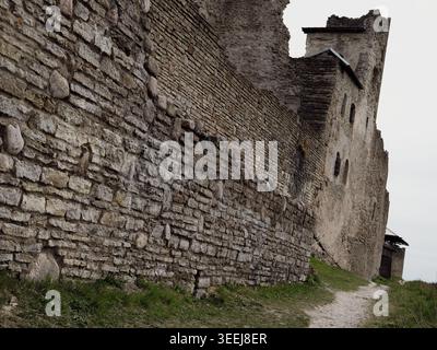 Ancient limestone wall and tower ruins of Rakvere Castle on a cloudy spring day in Estonia Stock Photo
