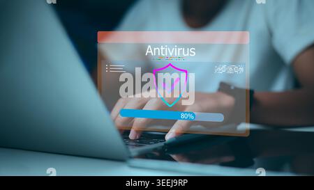 Hand using laptop with antivirus protection interface. Concept of cyber security, data privacy, system scanning, and defending computer from malware o Stock Photo