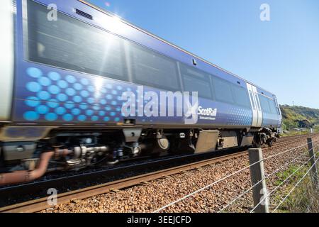 A scotrail train speeding along near Burntisland, Fife, Scotland Stock Photo