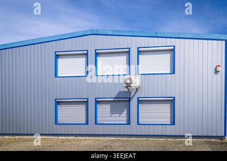 Split pump installed on a wall of industrial building, heating and cooling system Stock Photo