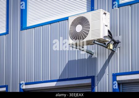 Split pump installed on a wall of industrial building, heating and cooling system Stock Photo