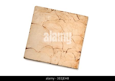 aged ceramic tile in beige color isolated on white background Stock Photo