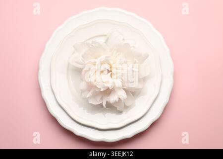 Beautiful table setting with peony flower on pink background, top view Stock Photo