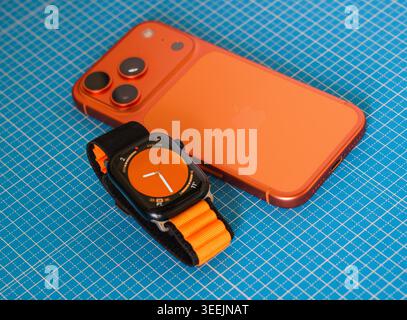 WARSAW, POLAND - MAY 11, 2026: An orange iPhone and Apple Watch Ultra ...