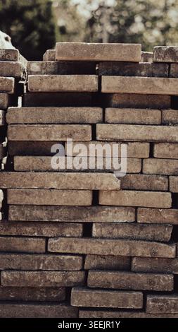 A stack of heavy stone paving slabs on a wooden pallet at a construction site Stock Photo