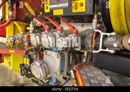 Dijon, France - May 9, 2026: Close up of the rear control board on a fire engine with various valves and pressure gauges. Hoses stored in reels ready. Stock Photo