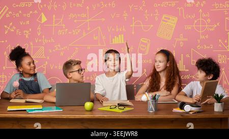 Group of Students in Classroom Engaging With Learning Materials and Sharing Ideas Together Stock Photo