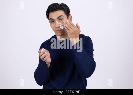 Man touching his face - looking confused or thoughtful with hand on cheek Stock Photo