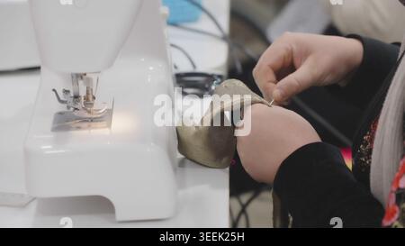Woman using sewing machine while guiding fabric through needle in workshop in pr Stock Photo