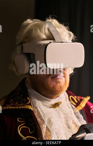 Portrait of young man wearing virtual reality headset with historical costume, exploring immersive technology and time travel concept. For gaming, innovation, entertainment marketing Stock Photo