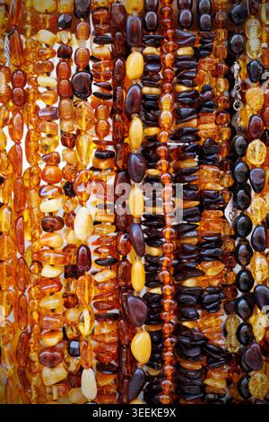Multiple strands of polished amber necklaces in various colors. Stock Photo