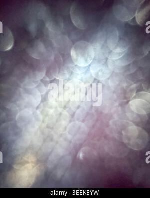 Soft blue and purple abstract bokeh background with layered glowing circles and gentle blur, creating a peaceful and atmospheric visual texture. Stock Photo