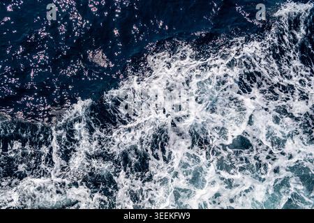 Ocean wave with white foam and dark blue water, top view sea texture Stock Photo