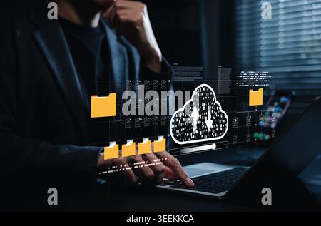 Cloud file backup and digital data storage management concept. Person using laptop with virtual folders, upload and download cloud icon, file transfer Stock Photo