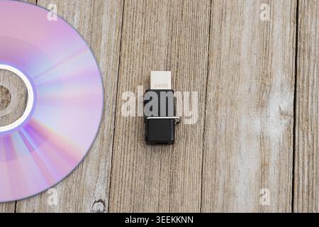 Compact disc and USB flash drive on rustic wood desk with copy space, for data storage, technology, backup, and media themes Stock Photo
