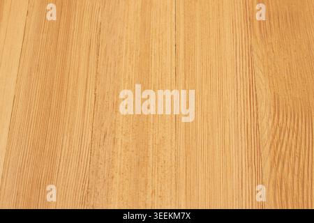 Warm golden wooden surface background with natural grain pattern for design, rustic decor, and product presentation. Stock Photo
