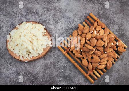 Almonds and sliced almonds on wooden surface Stock Photo