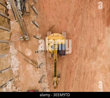 Top Down Aerial View Of Excavator On Commercial Construction Site Stock Photo