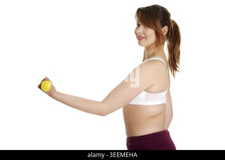 Young woman during fitness time and exercising with dumbbells, isolated on white background Stock Photo