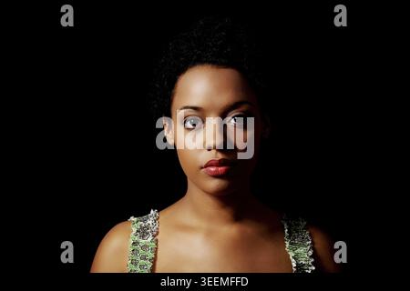 Portrait of beautiful serious afro american woman over black background Stock Photo