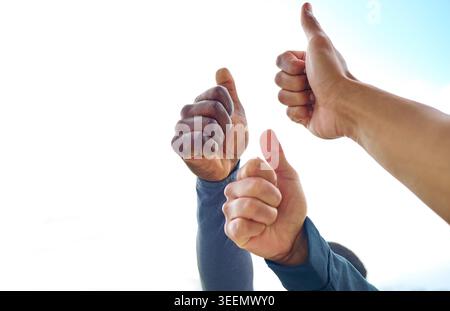 People, outdoor or hands with thumbs up in sky for fitness, motivation or approval in nature. Active, group or friends with like emoji, yes sign or OK Stock Photo