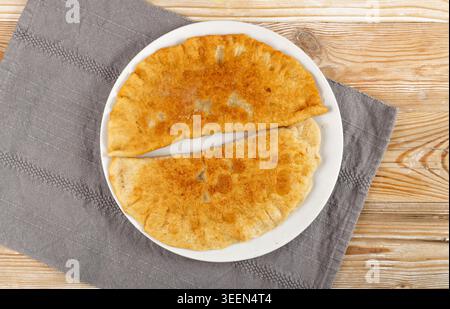 Deep-Fried Flat Pie Top View. Turnover with Filling of Ground Meat and Onions, Stuffed Chebureki, Tatar Cuisine, Asia, Eastern Europe Food Stock Photo