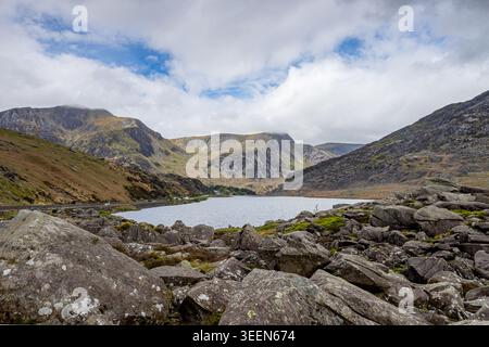 A wide-angle Landscape of Llyn Ogwen (Lake Ogwen) in the heart of Eryri (Snowdonia), North Wales. The foreground features the iconic large glacial bou Stock Photo