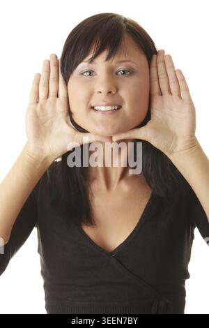 Young woman, framing her face with her hands Stock Photo