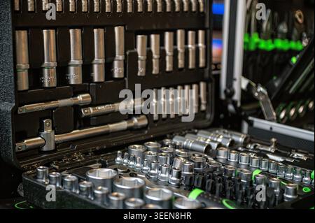 Various tools are arranged in a case, featuring sockets and ratchets for easy access. Stock Photo