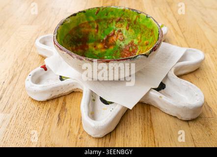 Dirty Plate, Dirty Dishes, Empty Bowl after Dinner, Finished Lunch with Soup Leftovers, Smeared Cream on White Plate on Wood Table Background Stock Photo