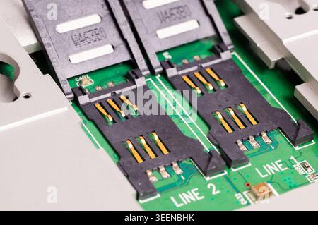 Close-up of dual SIM card slots on an electronic circuit board. Mobile communication hardware component used in smartphones, routers, and telecommunic Stock Photo