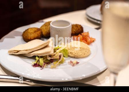Falafel in Restaurant, Fried Chickpea Round Pieces, Traditional Falafels, Spiced Arabic Halal Food, Falafel Set on Blurred Background Stock Photo